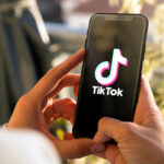 Tiktok on mobile phone Screen. Young woman holding a Smart Phone with Tik Tok app. ROSARIO, ARGENTINA -MARCH 15, 2023.